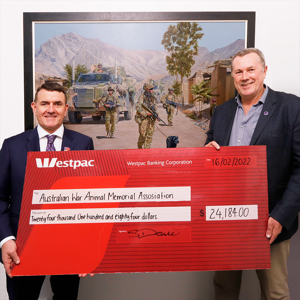 Stephen Davie, CEO of BrandNet with Dr Kendall Crocker accepting a donation to the Australian War Animal Memorial Organisation.
